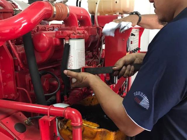 Technician servicing a diesel fire pump engine