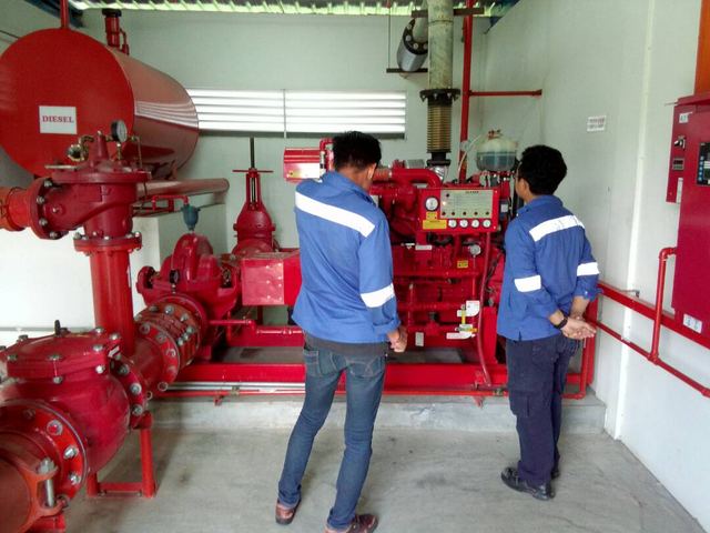 Technicians inspecting a diesel fire pump set