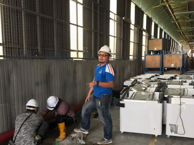 Site team at work inside an industrial warehouse