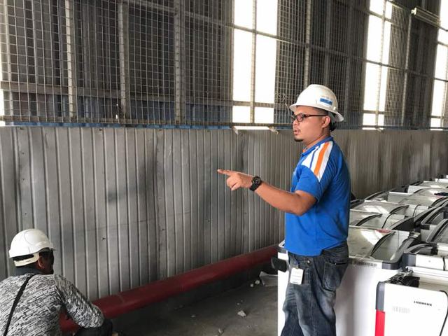 Supervisor directing pipework on an industrial site