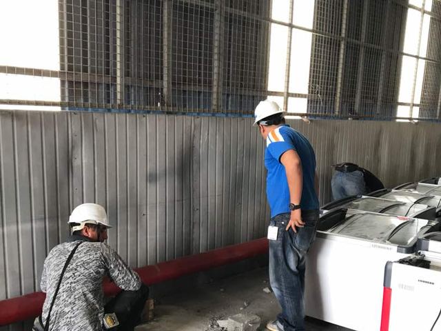 Technicians completing pipework at an industrial warehouse