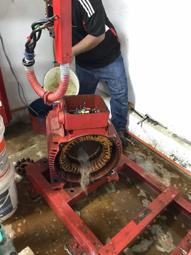 Technician overhauling a fire pump motor during scheduled maintenance