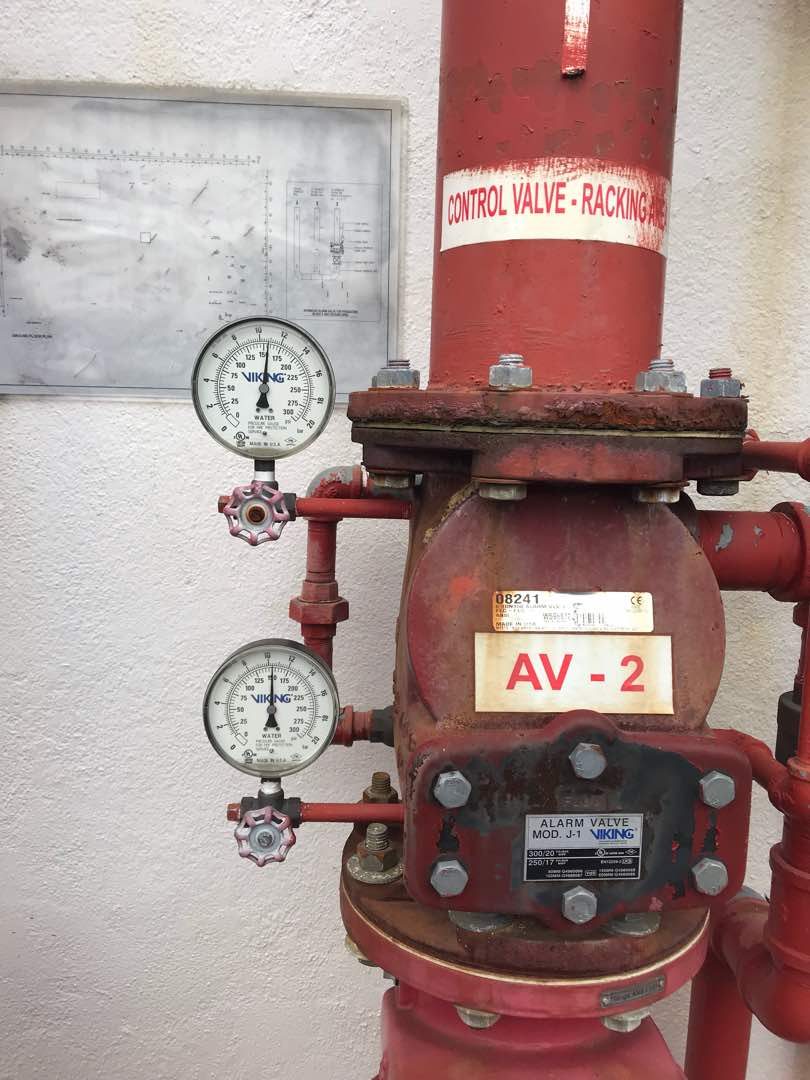 Close-up of a sprinkler system alarm valve and pressure gauges